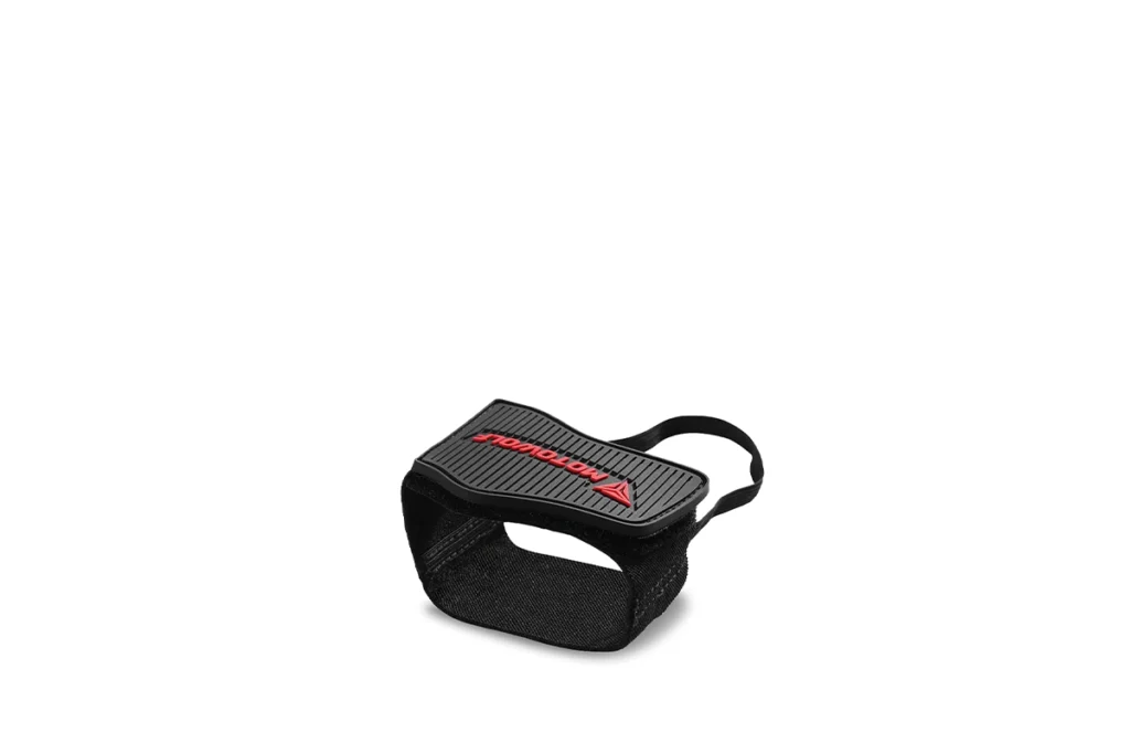 Black Motowolf motorcycle gear shift shoe shifter cover fitted securely over a rider's boot on a motorcycle footpeg