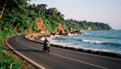 Long sandy coastline of Cox's Bazar beach with ocean waves crashing under a blue sky
