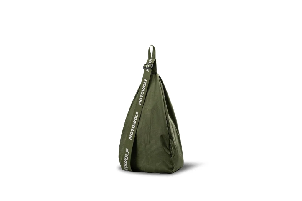 Black Motowolf Helmet Bag MB8 holding a full-face motorcycle helmet resting beside a sports bike