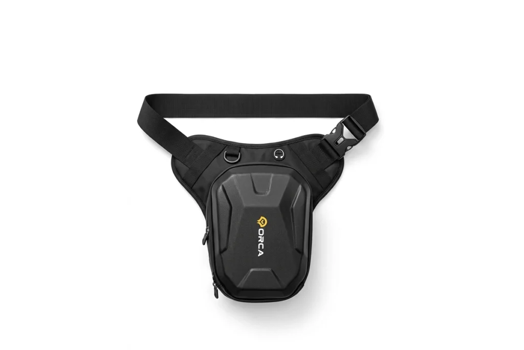 Black Orca Motorcycle Leg Bag strapped securely to a rider's thigh next to a motorcycle