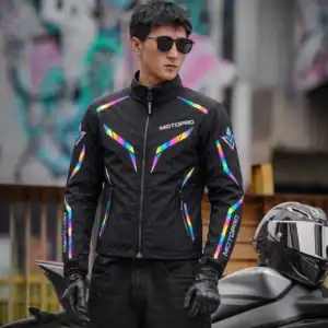 Motorcyclist wearing the MotoPro Windbreaker at night in the city with the reflective panels glowing brightly